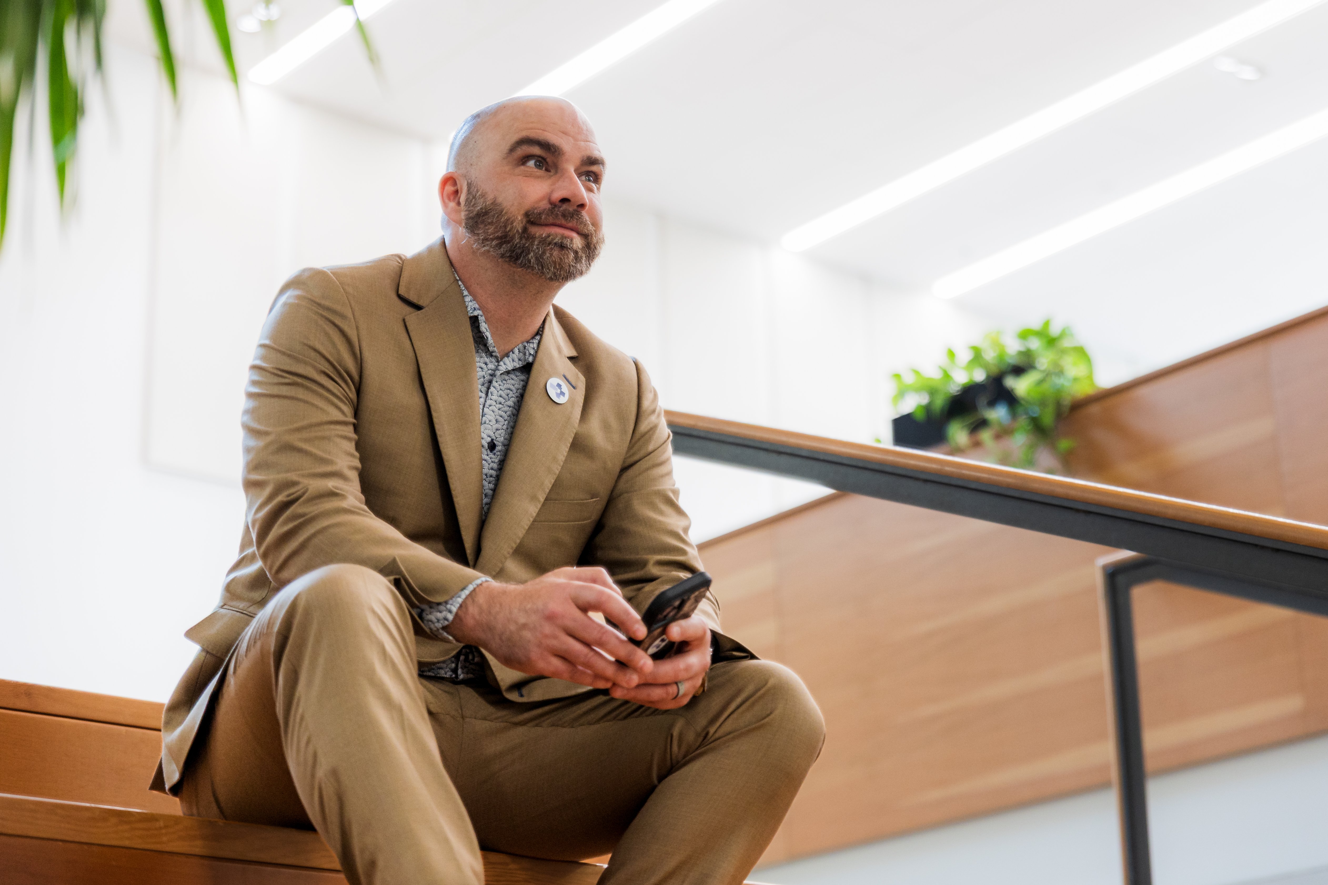 Sage partner in a suit sitting on steps