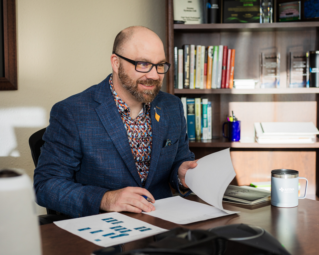 Man in an office looking through papers