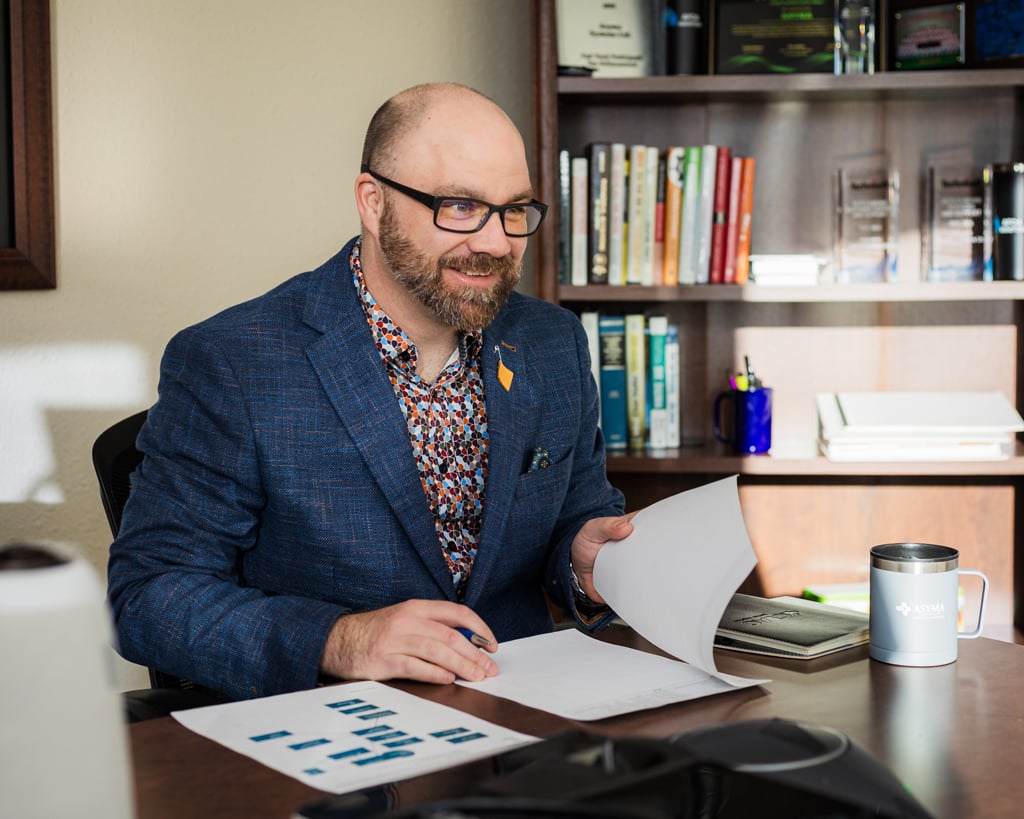 Man in an office looking through papers